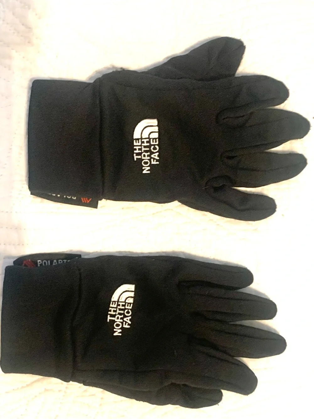 These north face gloves are mostly black, made with Polartec. Size XS